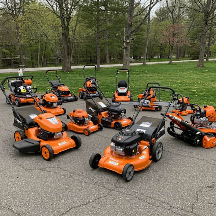 lawn mowers and outdoor equipment displayed on pavement