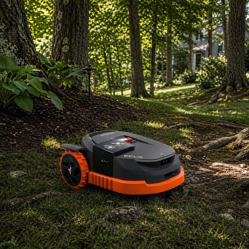 Robotic mower operating under dense tree canopy on a New Hampshire property with limited satellite visibility